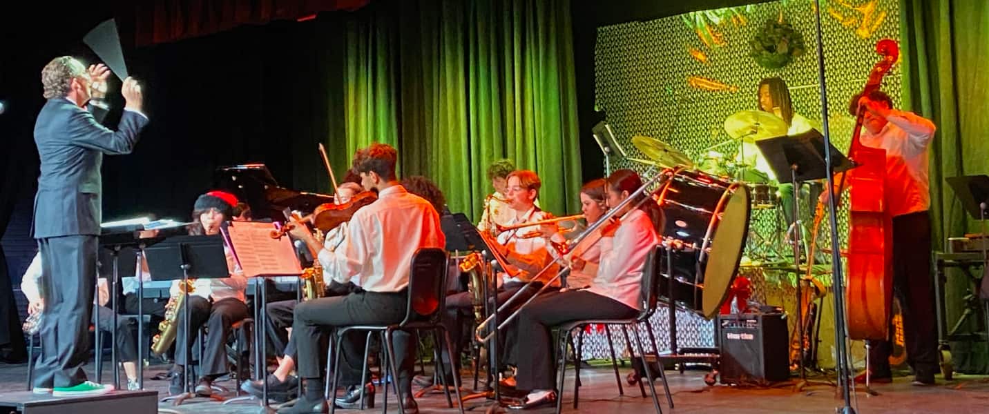 Music students on stage playing instruments