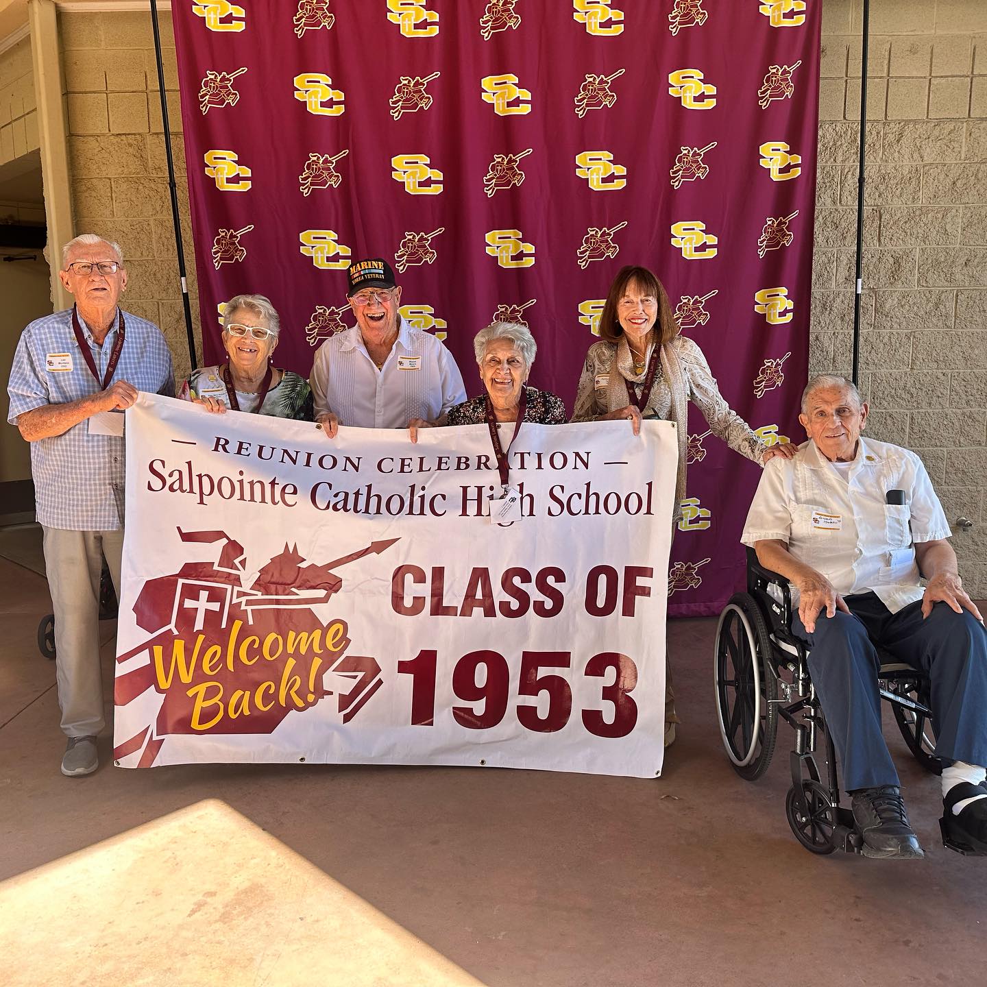 1953 graduates holding banner