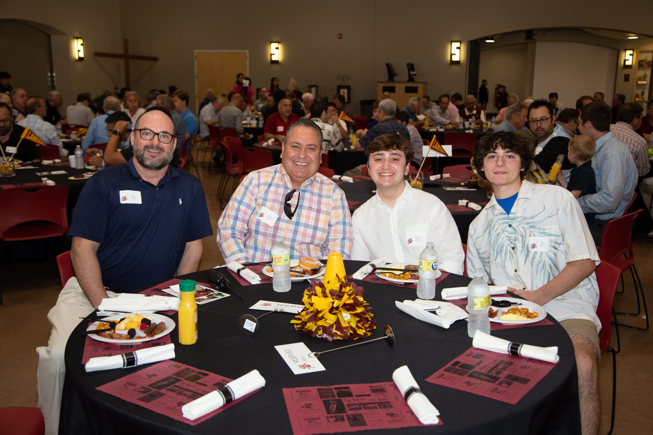 Parents and students at a table at an event