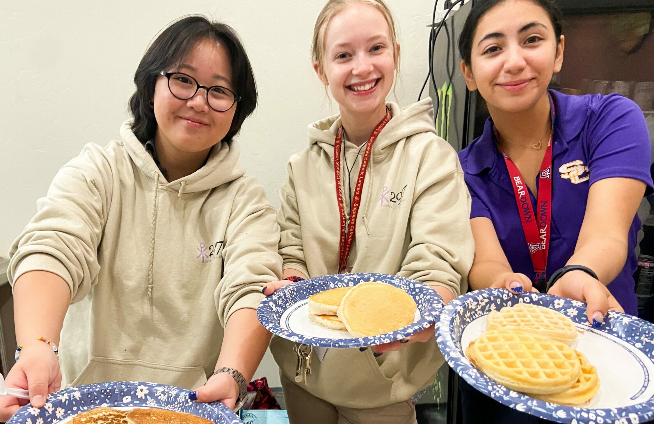 Students with pancakes and waffles