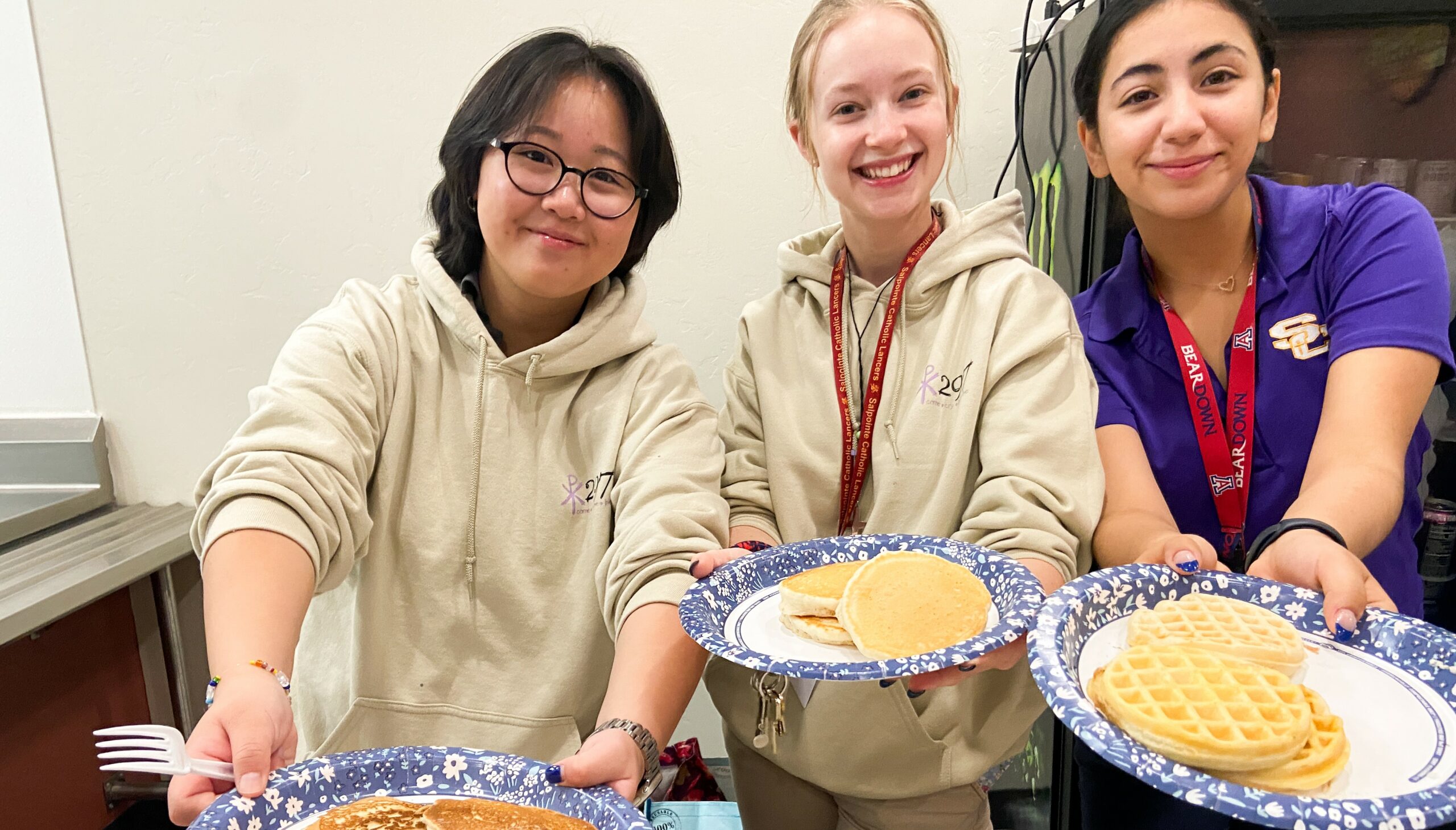 Students with pancakes and waffles