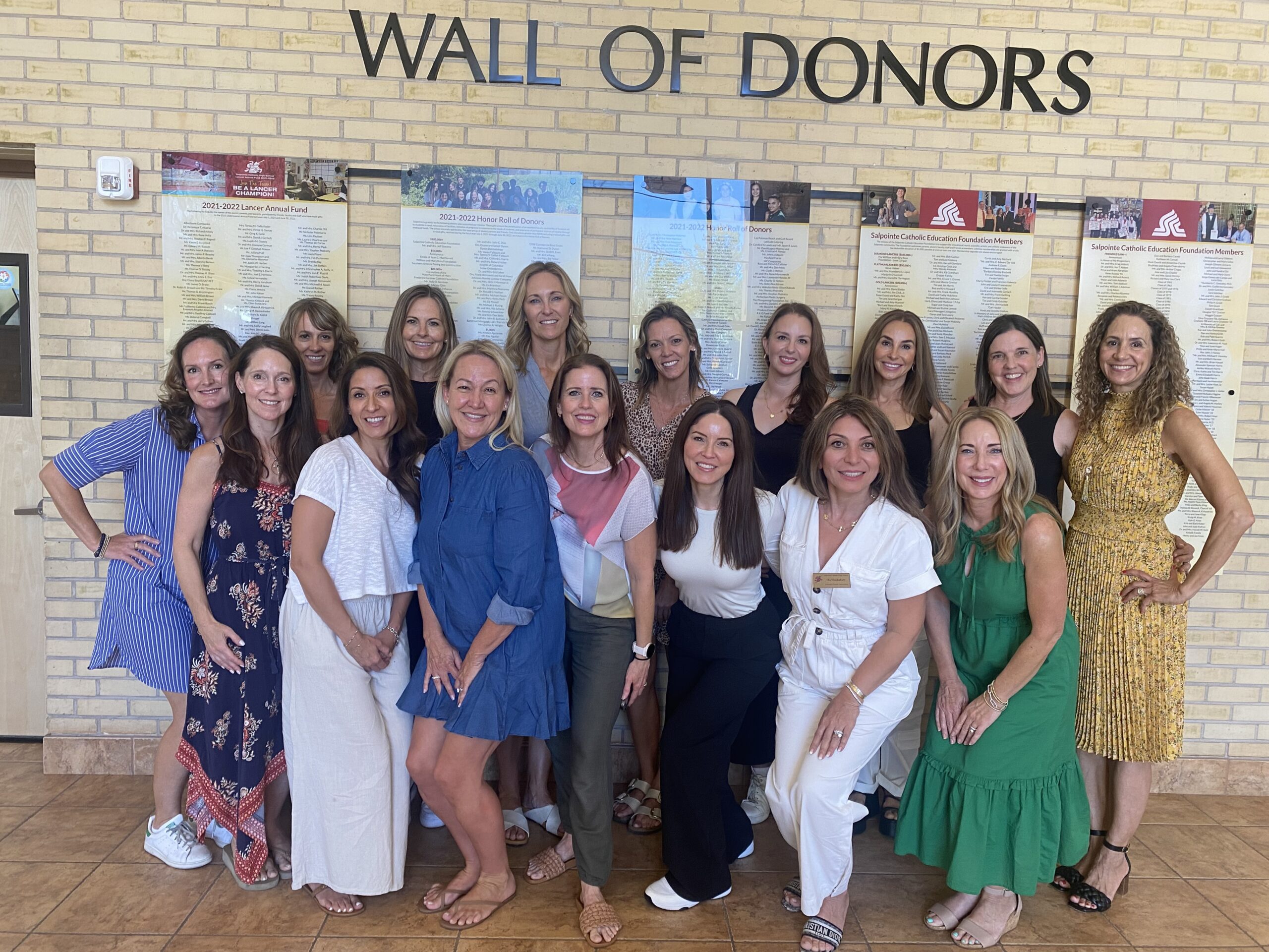 SPA Board photo 2024-25 in front of Wall of Donors