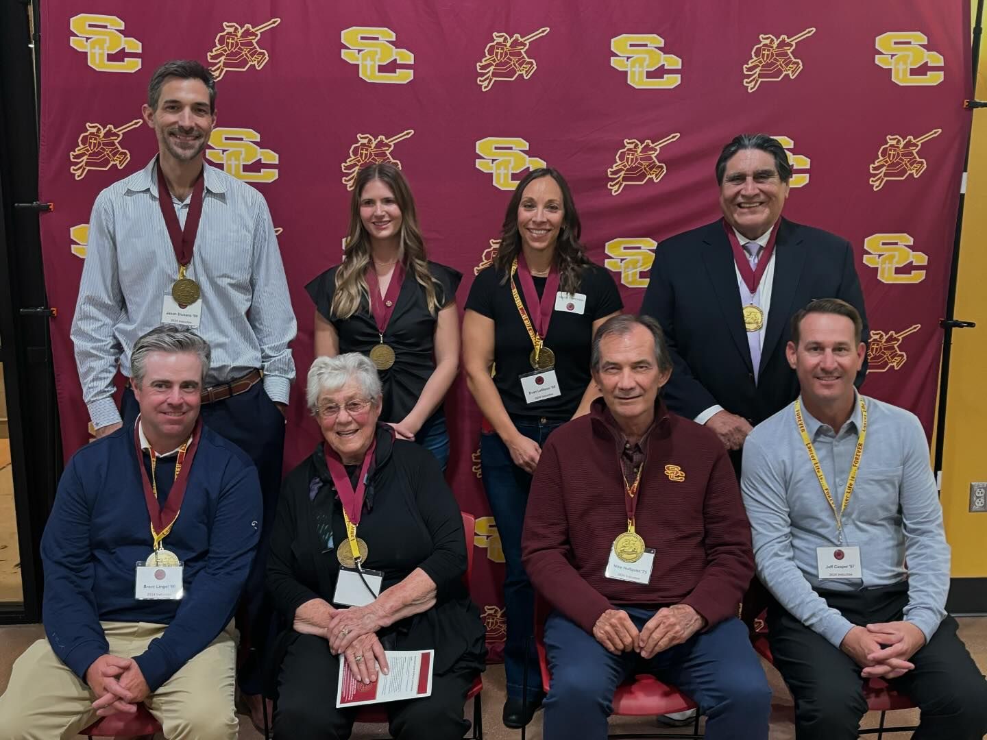 2024 Sports Hall of Fame recipients in front of back drop