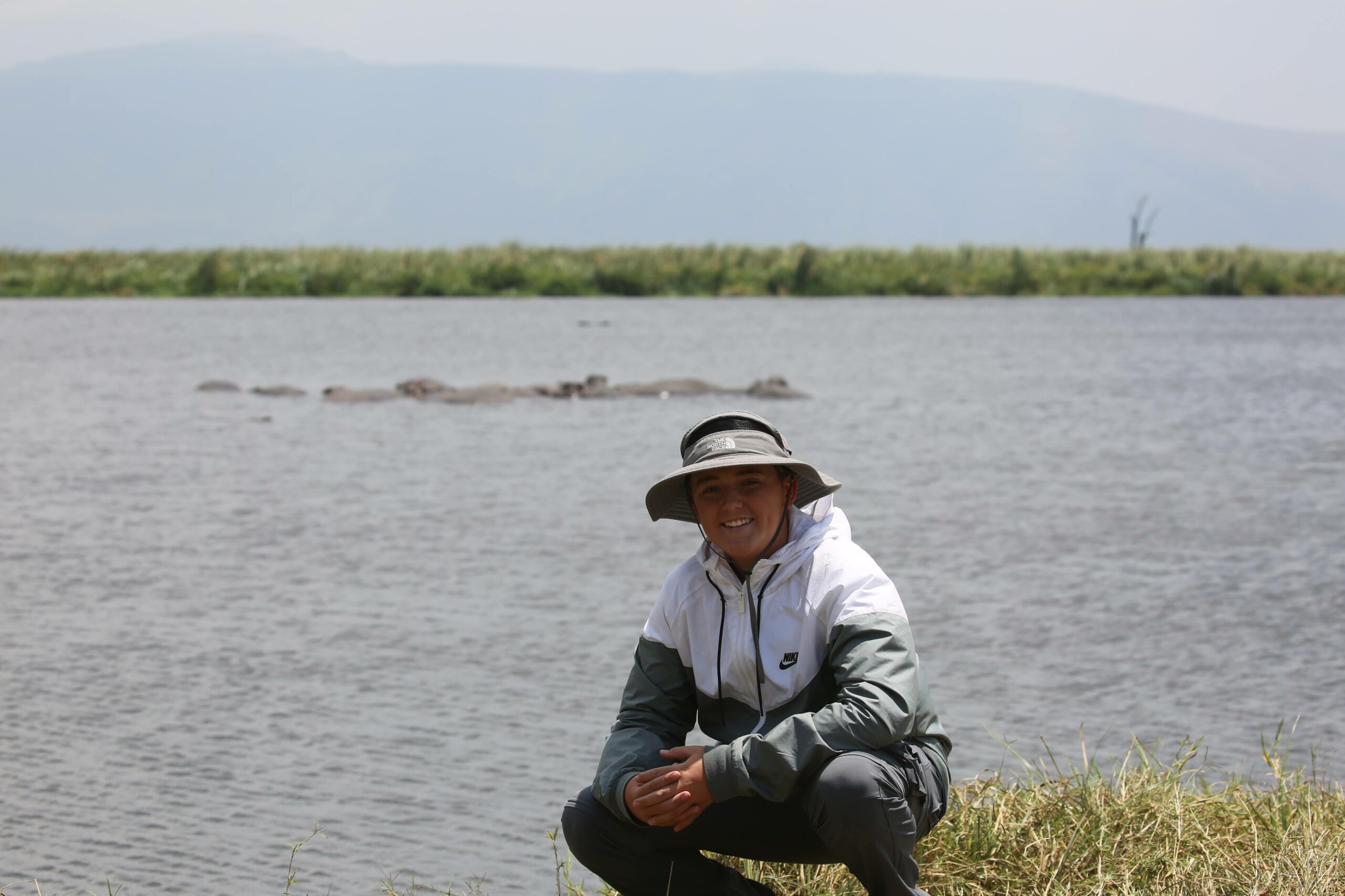 Student in Africa in front of water